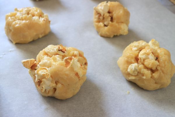 用湯匙挖取適當大小，放在鋪有烘焙紙的烤盤上，送入預熱180度的烤箱，烘烤約12分鐘，如怕露在外面的爆米花烤焦，中途可覆蓋一層鋁箔紙。