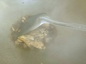 老薑用刀背拍扁炒鍋內放黑麻油爆香薑片