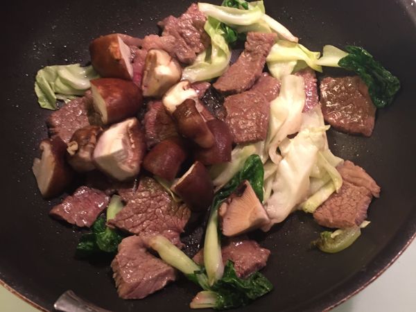 當牛肉塊開始出血就放香菇囉，然後就開始炒囉！