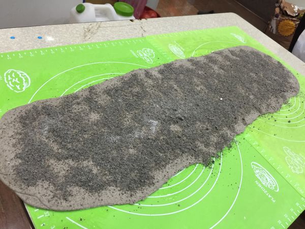 桌面先抹點油防沾，把麵皮桿成長方形，抹上沙拉油撒上芝麻內餡。