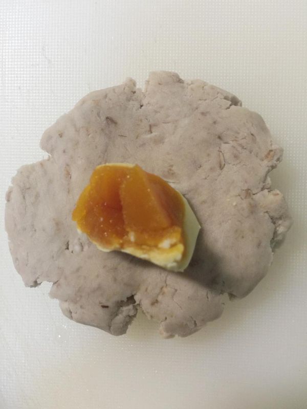 包入切半的鹹蛋黃，搓圓⋯
