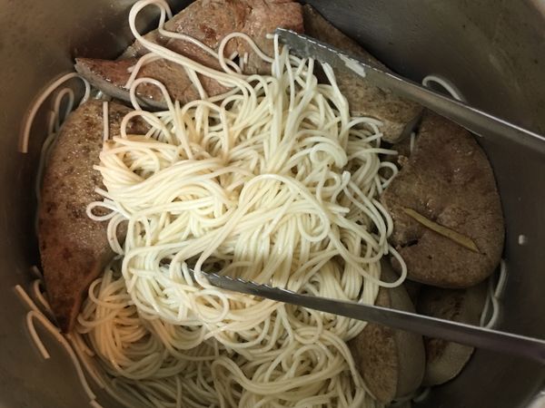 去一個鍋子放入些許的黑麻油、酒！
把燙好的麵線加入攪拌再把炒好的豬肝加入一起拌勻