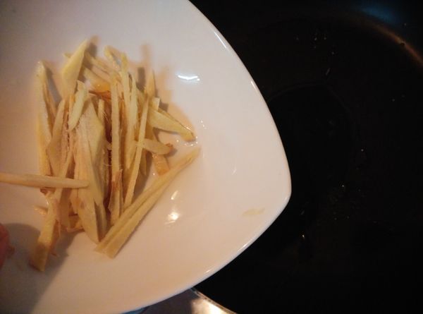 將薑洗淨切成薑絲，熱鍋，入1匙的橄欖油，放入薑絲爆香。