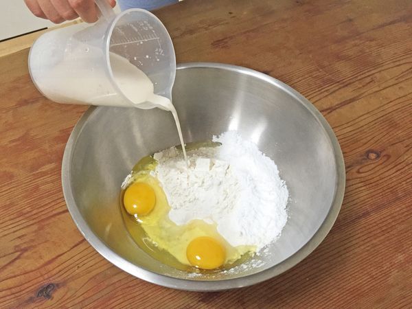 在大盆子裡倒入麵粉，挖成中空狀，把雞蛋、牛奶、鹽巴，邊揉合麵粉至光滑的表面，再放入奶油揉合。