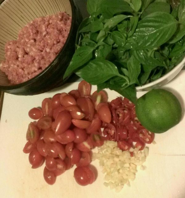 絞肉倒入碗中，先加入米酒及白胡椒粉攪拌均勻，最後再將香油拌入。
其餘食材洗淨，九層塔取葉備用，小番茄對半切，紅辣椒和蒜仁切末。