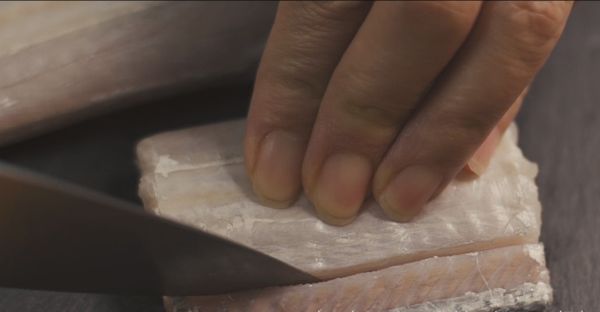 在魚的兩側上下處各劃一刀，深至魚骨處(不用切斷)