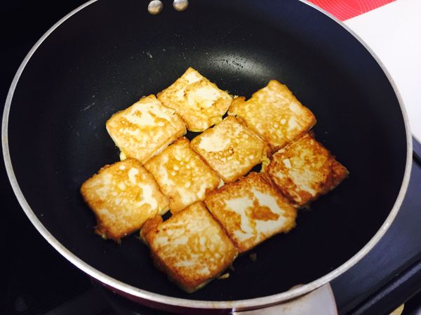少油，小火，將每一片豆腐小心下入鍋中，兩面煎至焦黃。