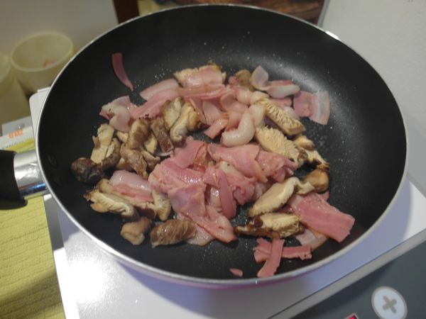 培根與香菇先下鍋炒,炒至培根出油