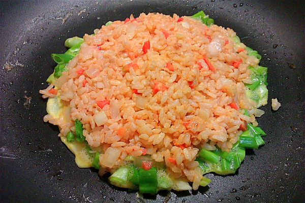 將茄汁洋蔥鮪魚飯平均分布於蔥蛋上。