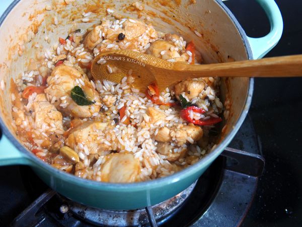 12.轉小火，或者是關火，將米倒入鍋中，一起拌炒。