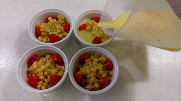 取1湯匙玉米粒擺放鮪魚上方，
蛋液+鮮奶+砂糖混合均勻後，倒入烤盅內。