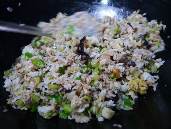 最後加入鮭魚肉、膳纖熟飯用鍋鏟背壓散飯粒拌炒均勻後加入炒蛋、蔥花，起鍋前在鍋鏟上沿鍋邊淋一小匙薄鹽醬油增加香氣，粒粒分明的炒飯即可上桌