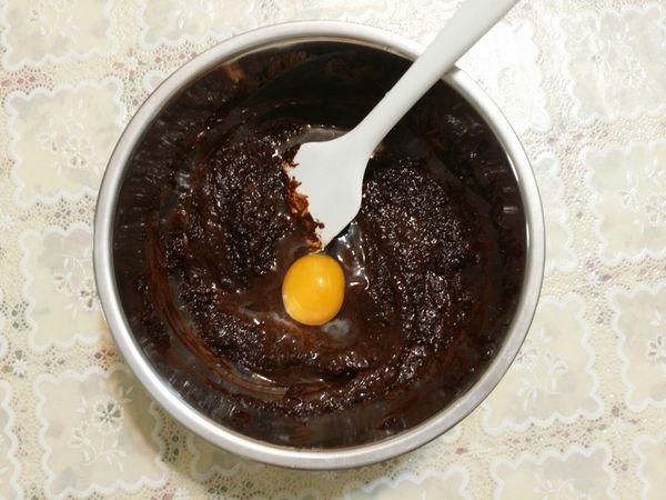 待混合物放涼至手可碰觸的溫度，分次加入蛋液（剛從冰箱取出的冷蛋，因為是要做fudgy brownie而非蓬鬆的巧克力蛋糕），持續攪拌至濃稠、有光澤的程度。