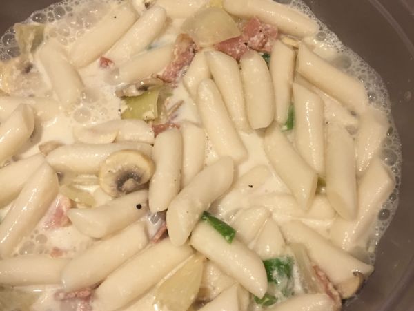 然後放入年糕，煮大約15分鐘，加入鹽，黑椒