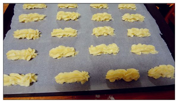 將扮好的麵糊裝入擠花帶中在烤盤上擠成條狀