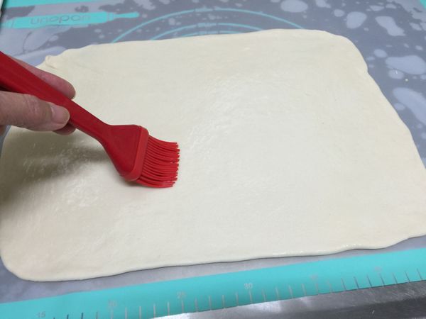 擀成光滑平整的長方型麵片，薄薄刷上ㄧ層葵花油（喜歡醎口味的可以抹上少許鹽巴；或蔥花+鹽巴））
