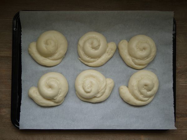 取出二次發酵完的麵糰，表面刷牛奶（或蛋液），在小蝸牛殼上擠上適量沙拉醬或卡士達醬，放入烤箱下層以180℃上下火烤15~20分鐘(視各家烤箱溫度而定) 。