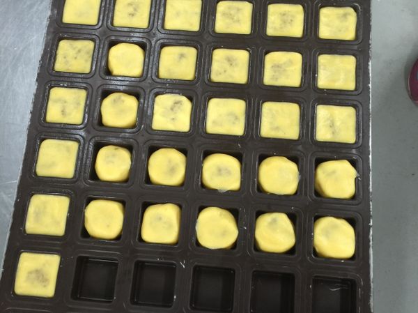 整形：手沾高粉，將餅皮壓扁包入鳳梨餡搓圓，入模用掌心壓平。
👉用的模是8格 x 6格 =48(個)