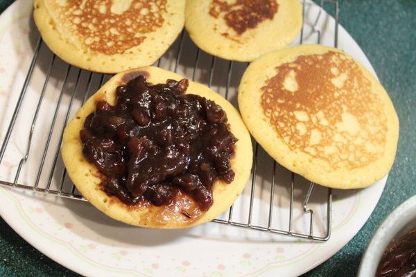 放在網架上放涼。直接放在盤子，熱氣會產生水蒸氣，弄濕麵皮。
抹上紅豆餡，再蓋上一片麵皮，就完成好吃的銅鑼燒。