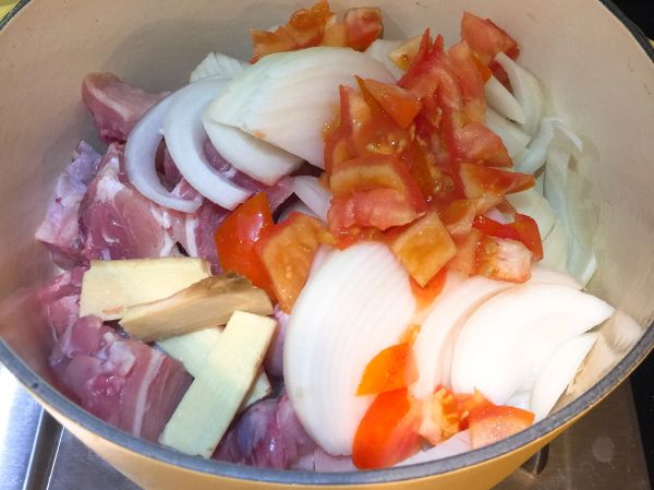 鑄鐵鍋 放入 雞腿肉， 洋蔥 ，新鮮蕃茄 ，大蒜稍微拌炒