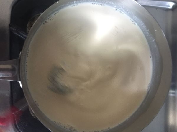 全部混合完成的布丁液移至爐火上，開小火不斷攪拌，避免鍋底燒焦了