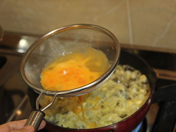 煮一鍋熱油, 待油溫升高, 篩入蛋液, 改轉大火炸至金黃酥脆取出, 放置廚房紙巾吸趣多餘油