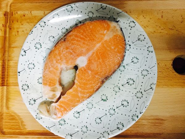 接著將鮭魚用鹽醃製10-15分鐘。之後將鮭魚擦乾，再下鍋乾煎，鮭魚本身就會出很多的油脂，不用再另外加太多油。煎完後鮭魚片取一半，然後再把鮭魚炒碎加入醬油2大匙和米酒1大匙，炒到醬汁收乾。