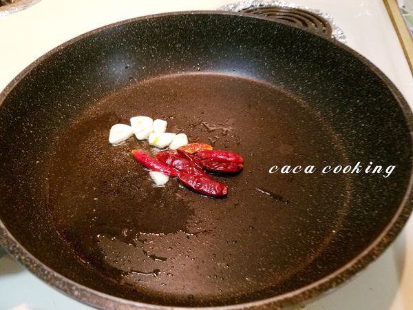 熱鍋加1匙油，把蒜片、乾辣椒下鍋爆香。