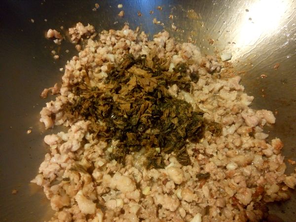 加入梅干菜一起拌炒，約炒兩分鐘
