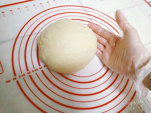 此時，捲起袖子吧！使出洪荒之力的時候到了！手工甩打麵糰約200下，直到撐出較光滑的薄膜。抓著麵糰一角用力甩打在揉麵墊上，對折、再抓住另一角甩打出去，一直重複到筋疲力盡，差不多就有八成修為了😂
(甩打的樣子太狂野拍不出來，請上網搜尋影片比較詳細)