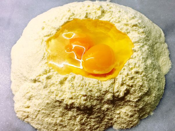 小麥粉中間撥個洞築成粉牆
蛋打在中間
以叉子將四周的粉往中間撥，和蛋和在一起
再用手搓揉混合麵糰至如黏土狀即可