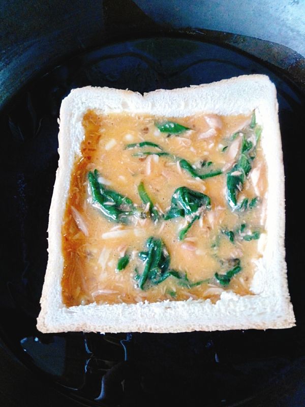 用兩個土司邊疊起當模型。
熱鍋，下油，放入土司邊，將拌勻的蛋液倒入土司邊內。